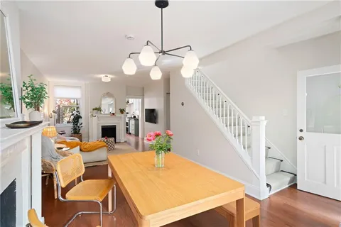 a view of a dining room with furniture wooden floor and chandelier