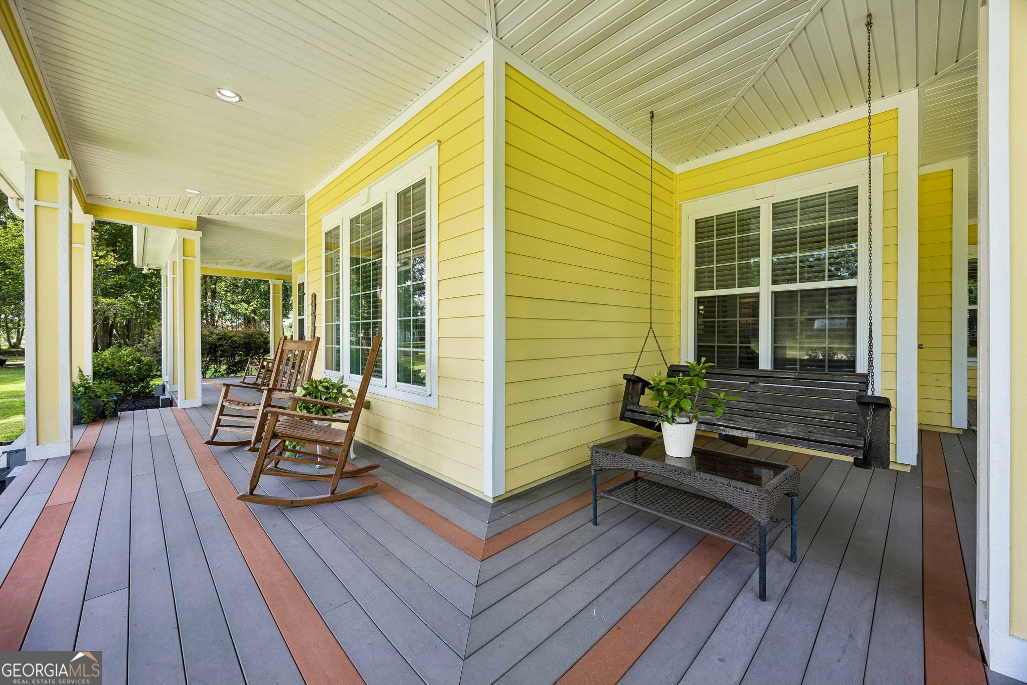 706 Hopewell Point Road White Oak, GA 31568 - Photo 62 of 84 Thoughtfully designed outdoor living spaces include both a porch swing and rocking chairs, creating inviting places to unwind throughout the day.