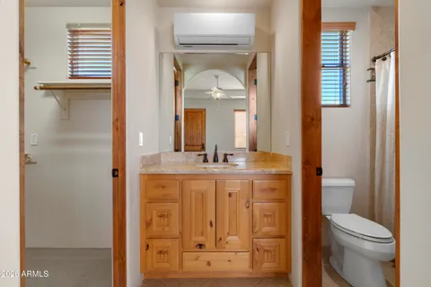 a bedroom with a large bed and a window