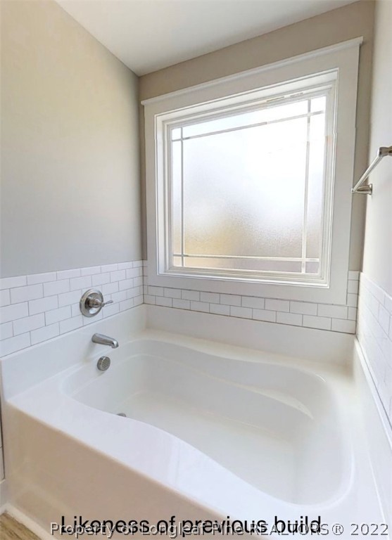 256 Crupper Lane Raeford, NC 28376 - Photo 14 of 30 a white bath tub sitting next to a window