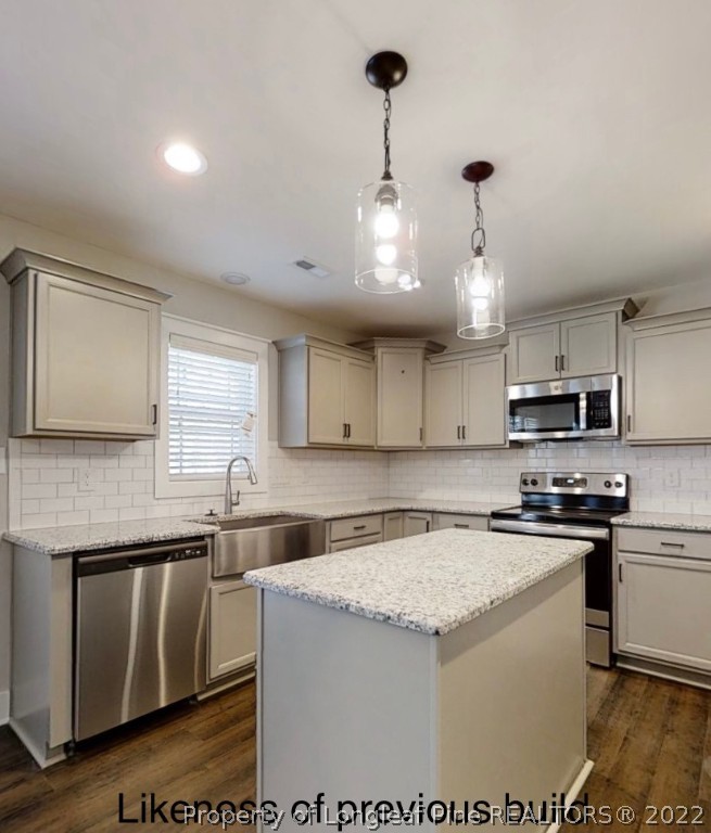 256 Crupper Lane Raeford, NC 28376 - Photo 23 of 30 a kitchen with stainless steel appliances granite countertop a sink a stove and a refrigerator