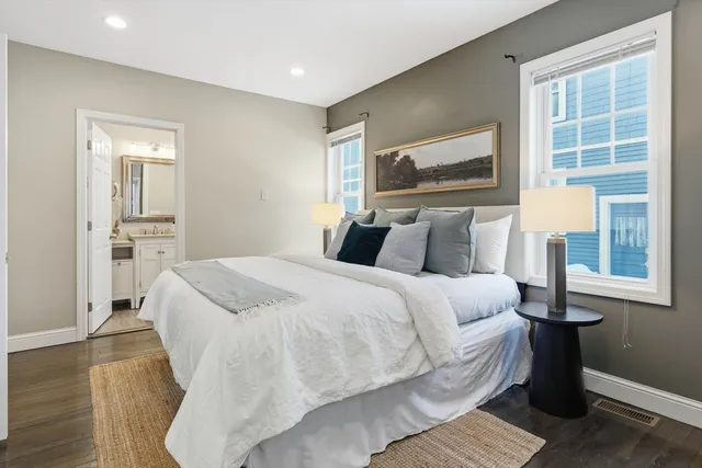 a bathroom with a toilet sink vanity and mirror