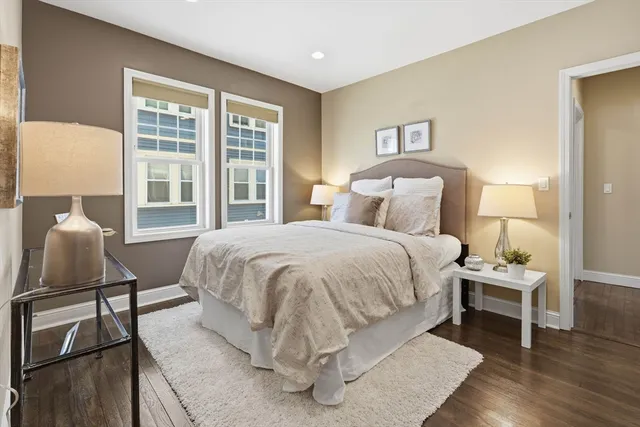 a large bed sitting in a bedroom and lamp