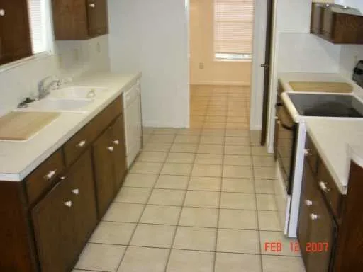 a view of hallway with a window and a white door