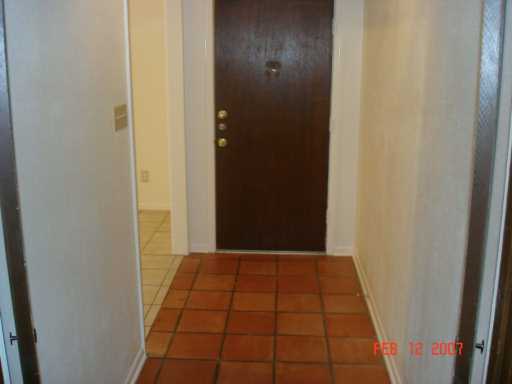 4533 Stonegate Way Corpus Christi, TX 78411 - Photo 6 of 10 a view of hallway with a window and a white door