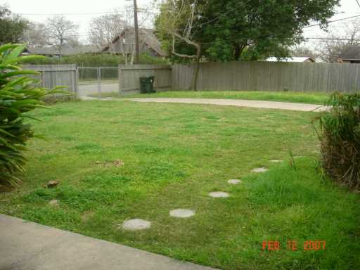 4533 Stonegate Way Corpus Christi, TX 78411 - Photo 9 of 10 a backyard of a house with lots of green space and lake view