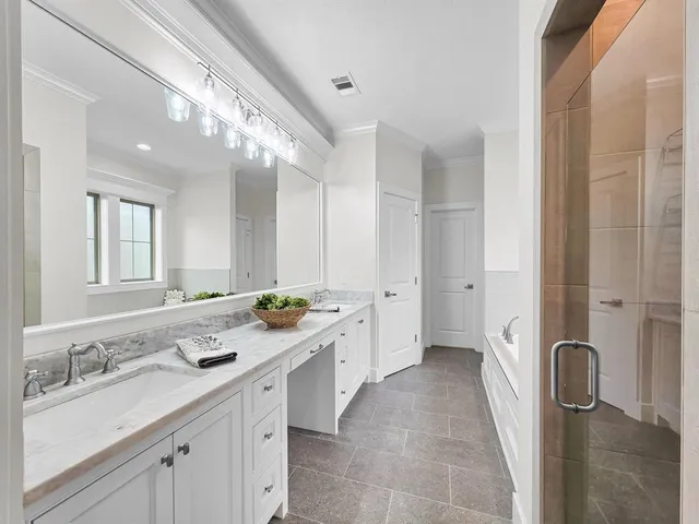 a spacious bathroom with a double vanity sink mirror double and shower