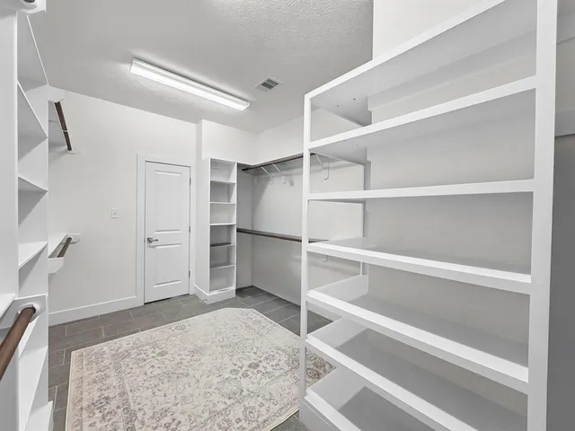 a view of an empty walk in closet