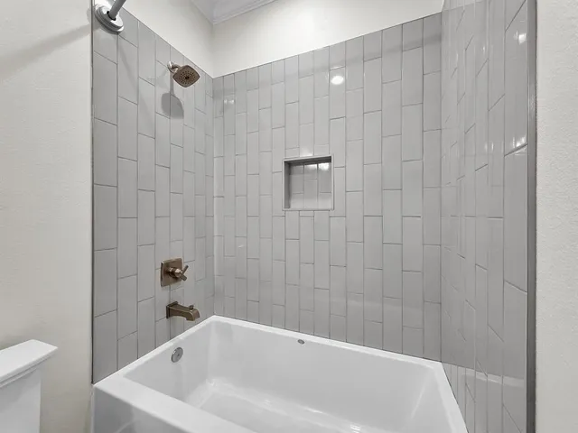 a bathroom with a white bath tub and a shower