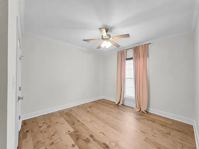 an empty room with an empty space and a ceiling fan