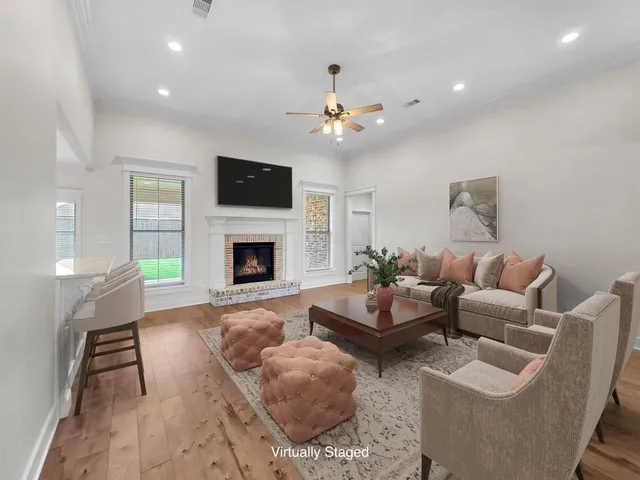 a living room with furniture a flat screen tv and a fireplace