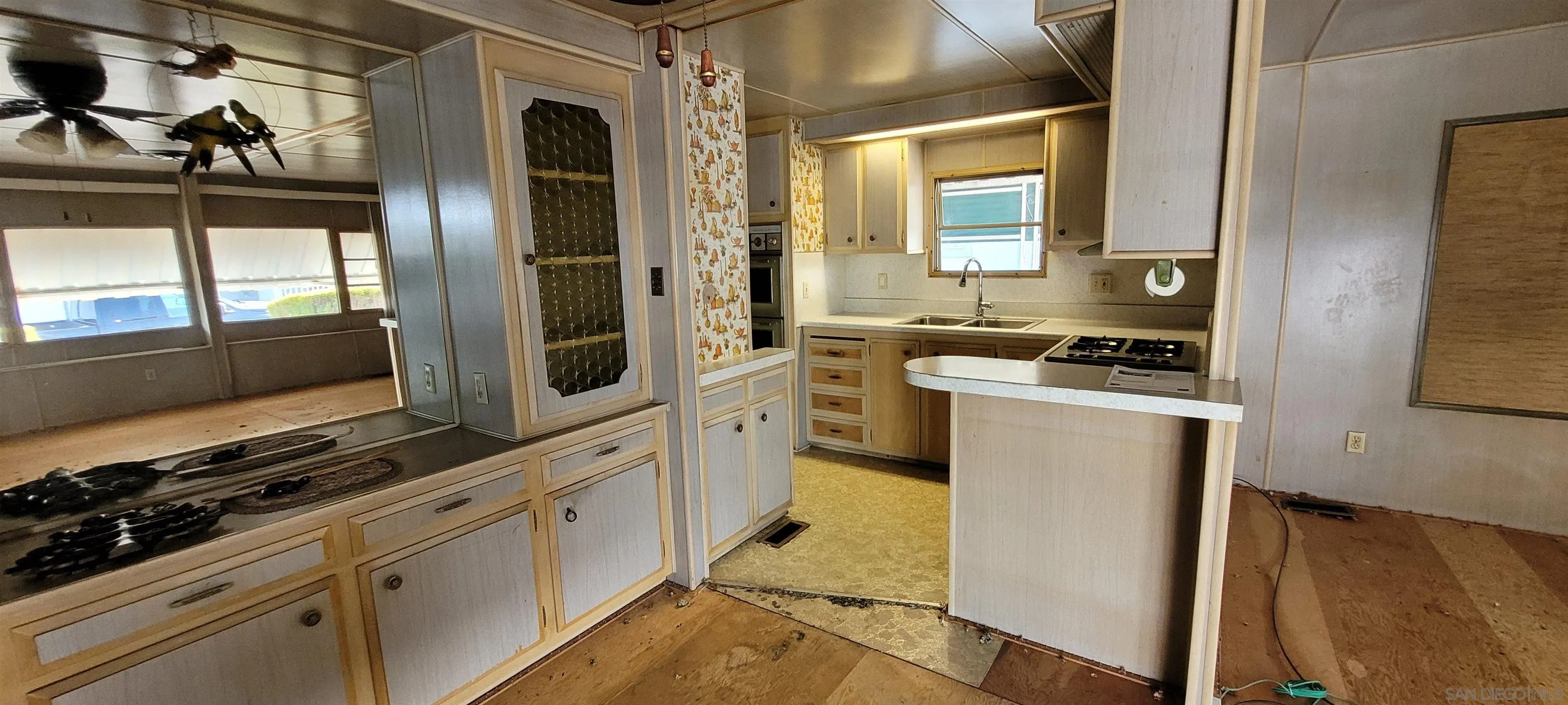 13644 Marigold Drive, Unit 176 Poway, CA 92064 - Photo 5 of 11 a kitchen with stainless steel appliances a stove a microwave and a refrigerator