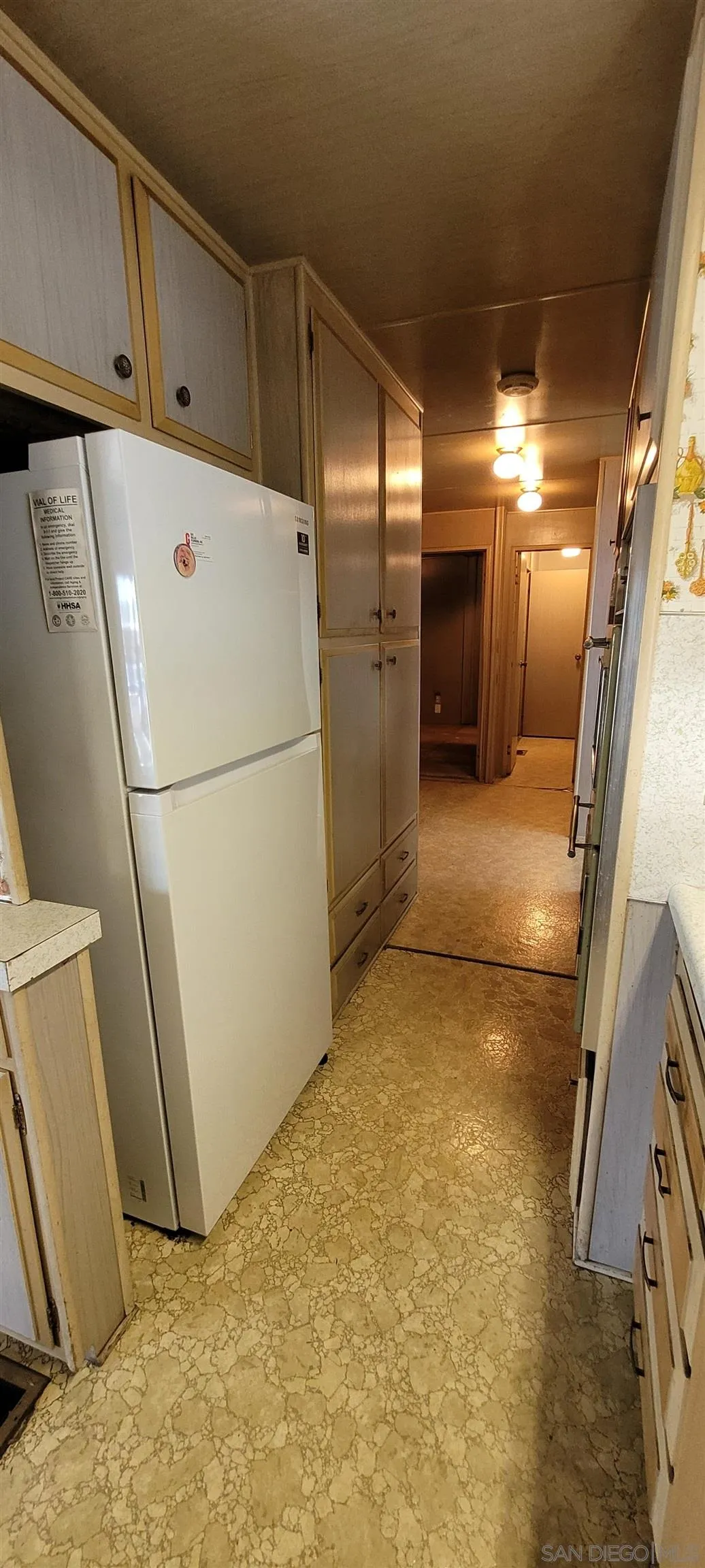 13644 Marigold Drive, Unit 176 Poway, CA 92064 - Photo 8 of 11 a view of a refrigerator in kitchen and utility room