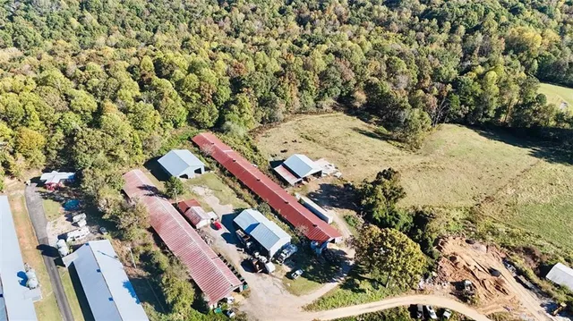 an aerial view of a house with a yard and lake view