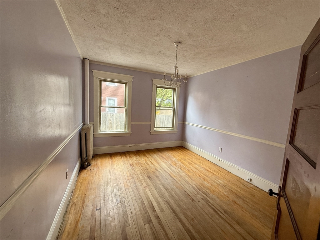 22 Baker Street Worcester, MA 01603 - Photo 11 of 35 a view of an empty room with wooden floor and a window