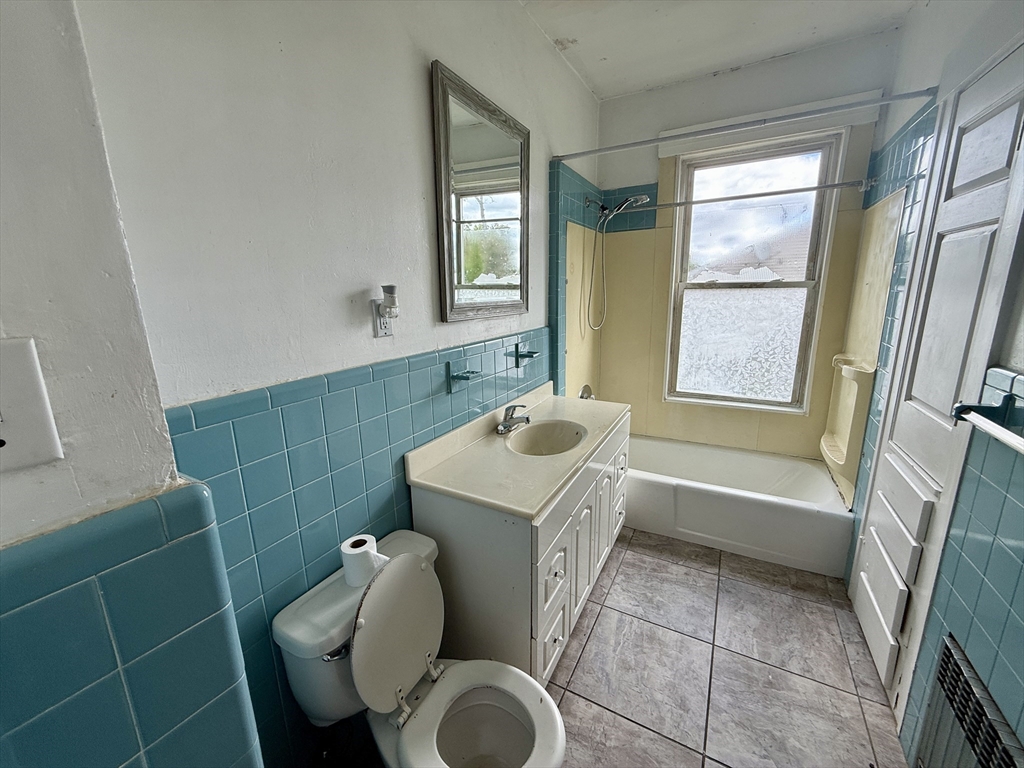 22 Baker Street Worcester, MA 01603 - Photo 16 of 35 a bathroom with a sink toilet and shower