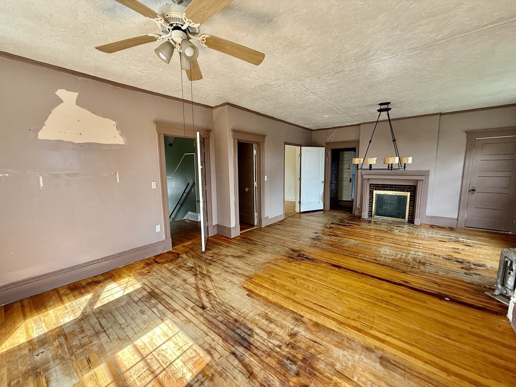 22 Baker Street Worcester, MA 01603 - Photo 19 of 35 a view of an empty room with chandelier fan and wooden floor