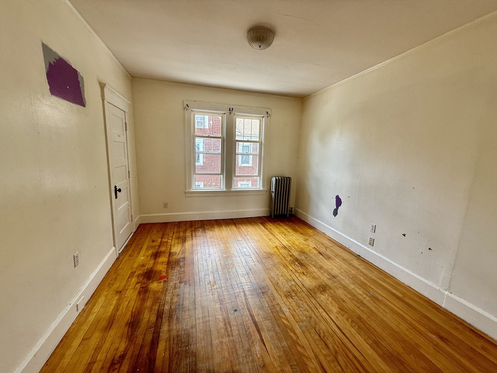 22 Baker Street Worcester, MA 01603 - Photo 21 of 35 an empty room with wooden floor and windows