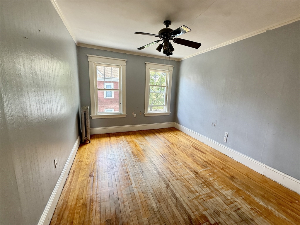 22 Baker Street Worcester, MA 01603 - Photo 22 of 35 a view of empty room with wooden floor and fan