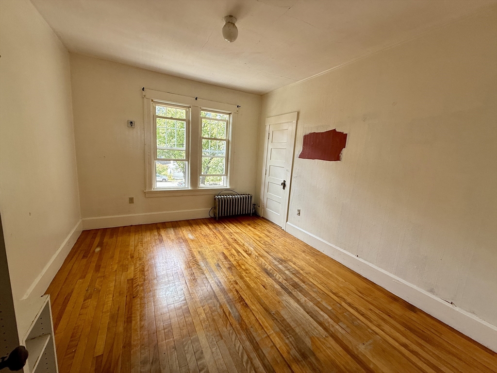 22 Baker Street Worcester, MA 01603 - Photo 23 of 35 a view of an empty room with wooden floor and a window