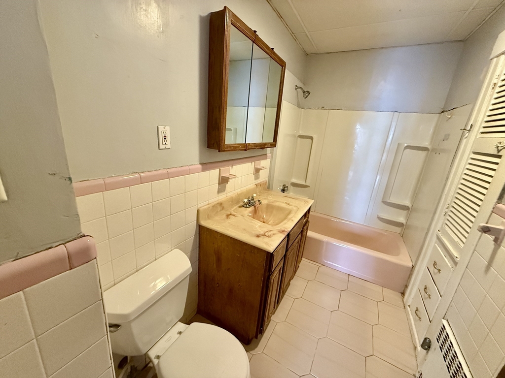 22 Baker Street Worcester, MA 01603 - Photo 26 of 35 a bathroom with a sink a toilet and mirror