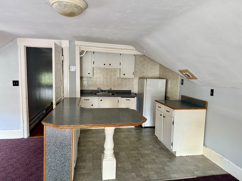 22 Baker Street Worcester, MA 01603 - Photo 32 of 35 a kitchen with stainless steel appliances granite countertop a sink a refrigerator and a stove