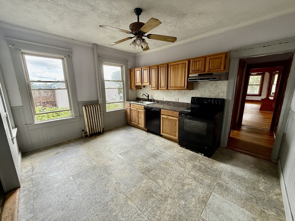 22 Baker Street Worcester, MA 01603 - Photo 7 of 35 a kitchen with a stove a sink and a refrigerator
