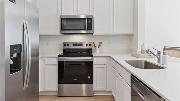 a kitchen with a sink and steel stainless steel appliances