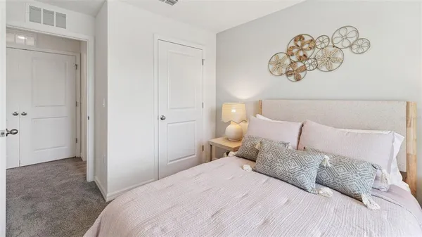 a bedroom with a bed and painting on the wall