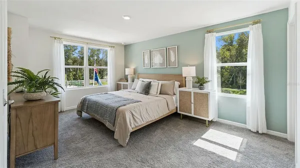 a bedroom with a large bed and a window