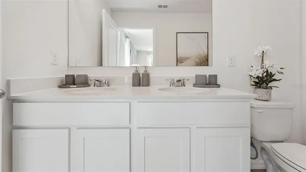 a bathroom with a sink toilet and a mirror