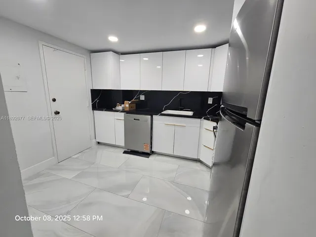 a bathroom with a double vanity sink toilet and shower