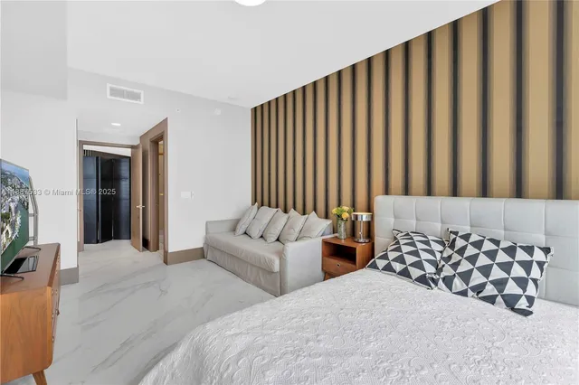 a bathroom with a glass door shower and a sink