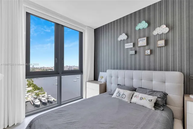 a bedroom with a bed and a large window