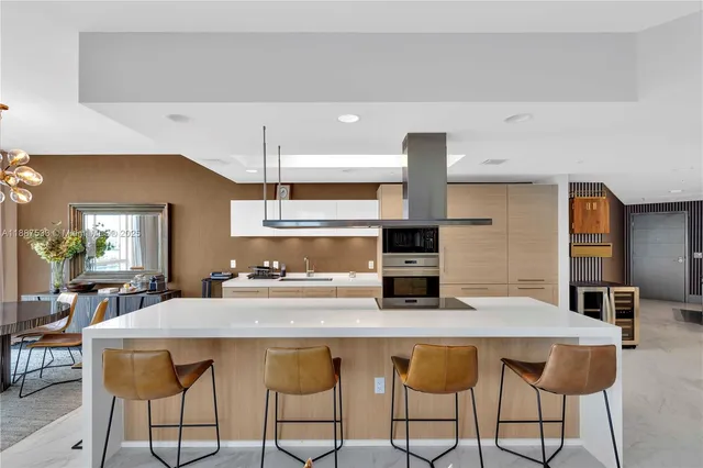 a dining room with furniture a chandelier and wooden floor