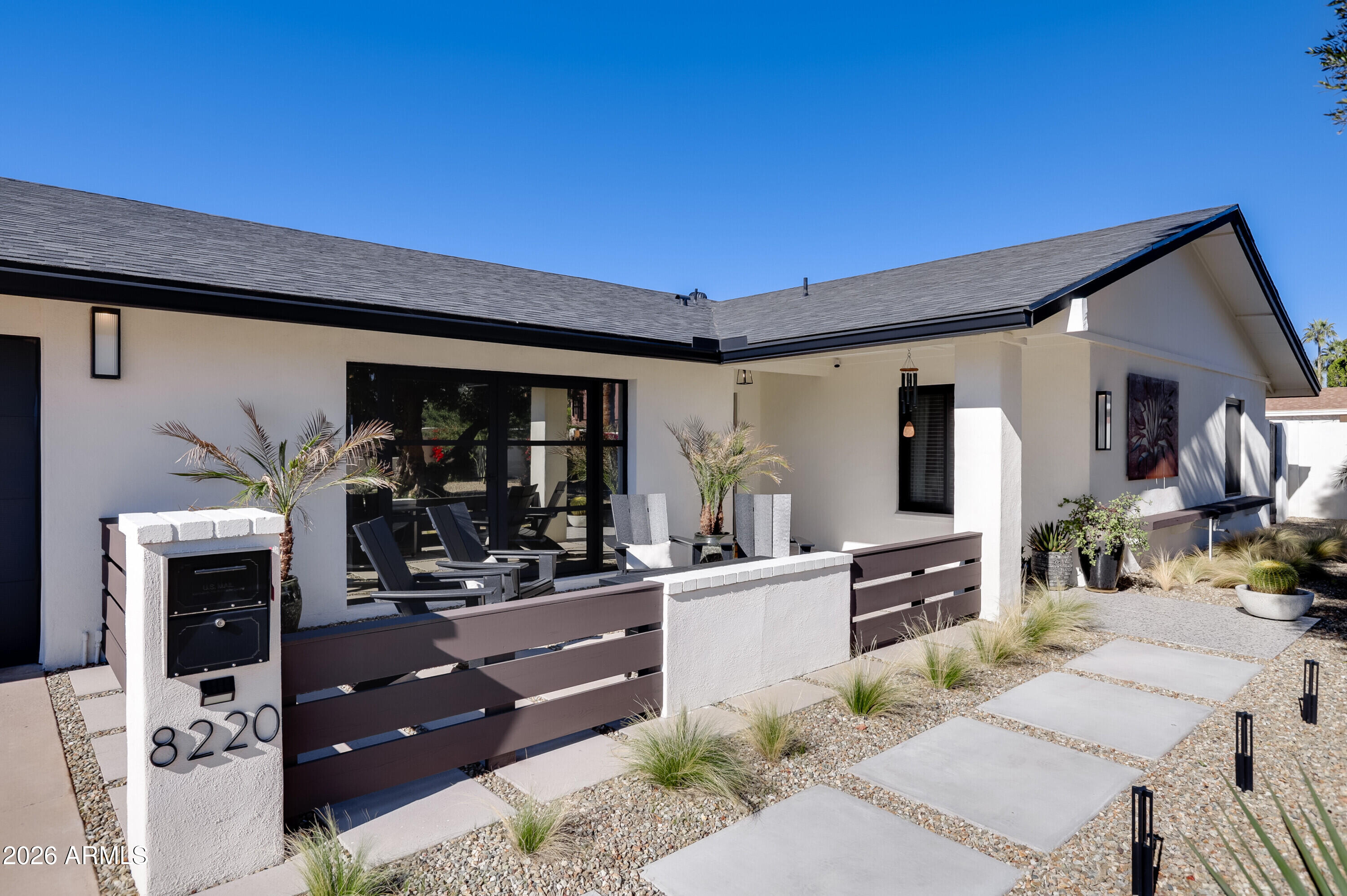 8220 North 1st Avenue Phoenix, AZ 85021 - Photo 2 of 53 a living room with furniture a flat screen tv and kitchen view