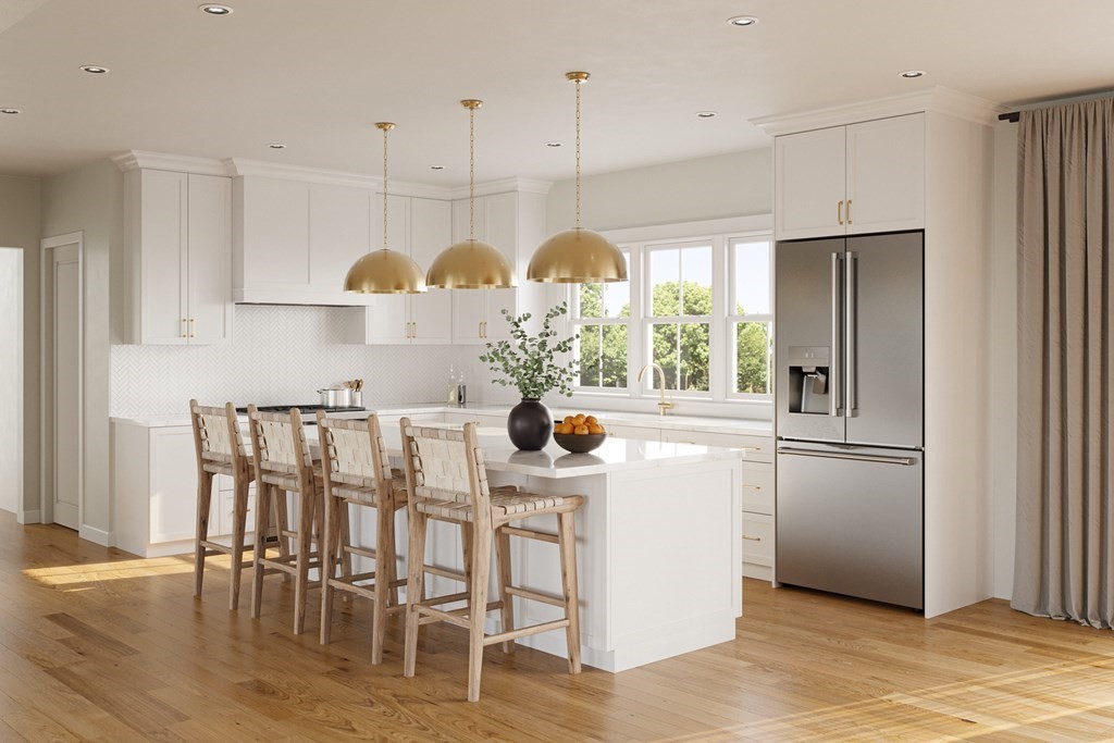 8 Rowell Road Danvers, MA 01923 - Photo 2 of 6 a kitchen with stainless steel appliances granite countertop a refrigerator a sink dishwasher a dining table and chairs with wooden floor