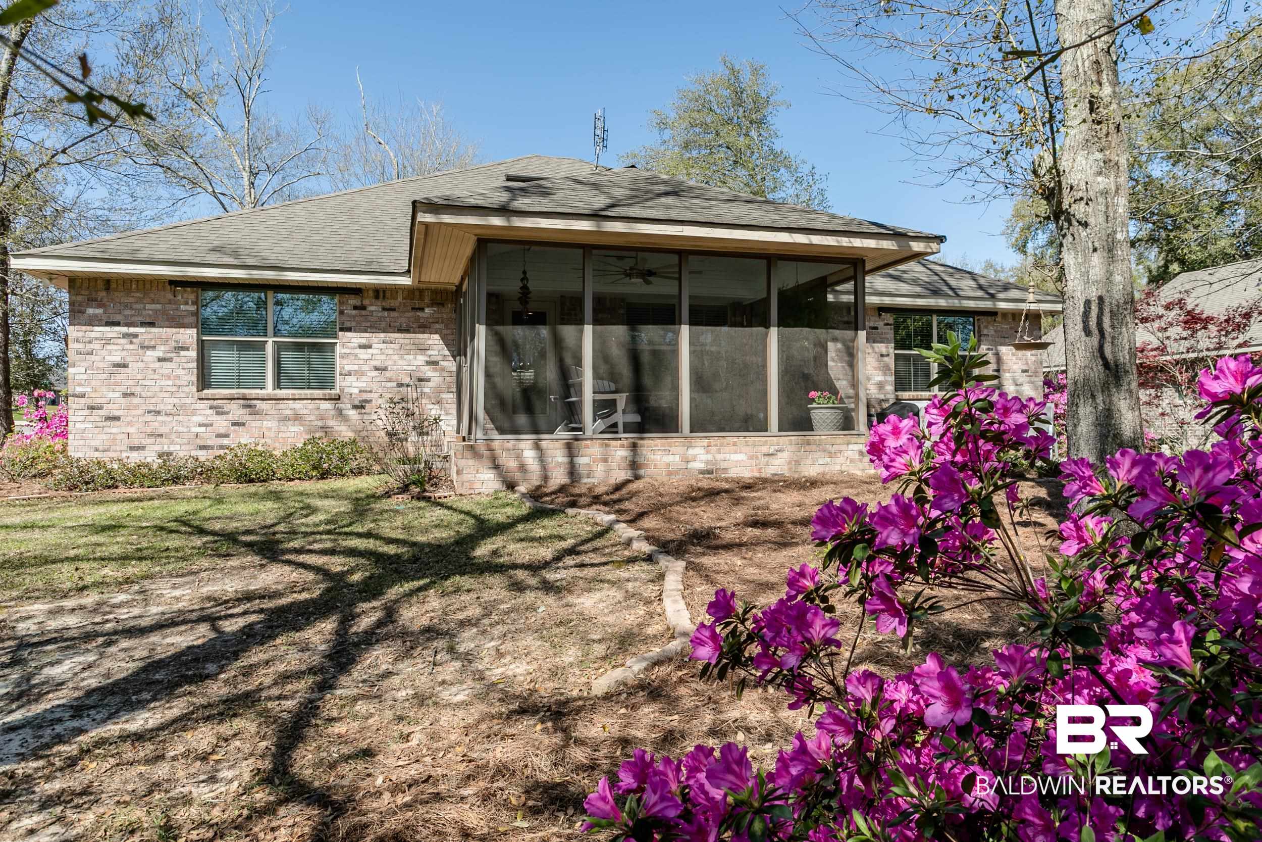 13154 Vincent Court Foley, AL 36535 - Photo 35 of 41 Back of house with a lawn, a shingled roof, a sunroom, and brick siding