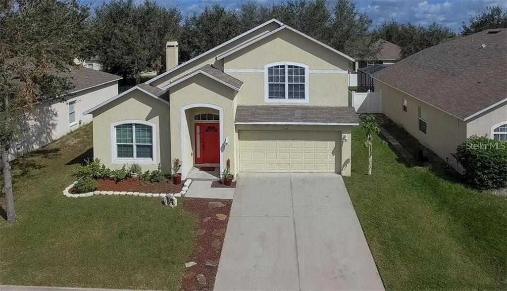 5085 Shale Ridge Trail Orlando, FL 32818 - Photo 1 of 1 a front view of a house with a yard