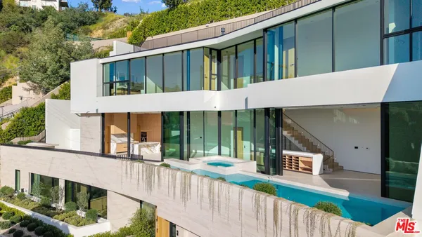 a view of a house with wooden fence