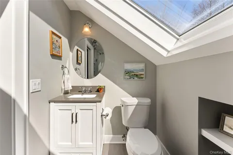 a bathroom with a toilet sink and mirror