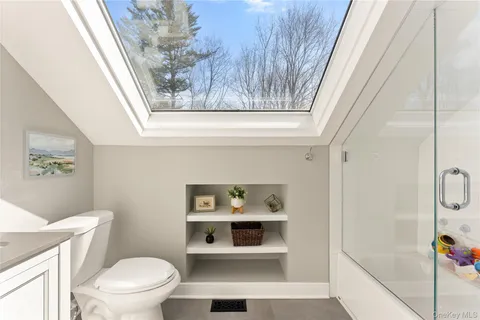 a bathroom with a toilet and a shower