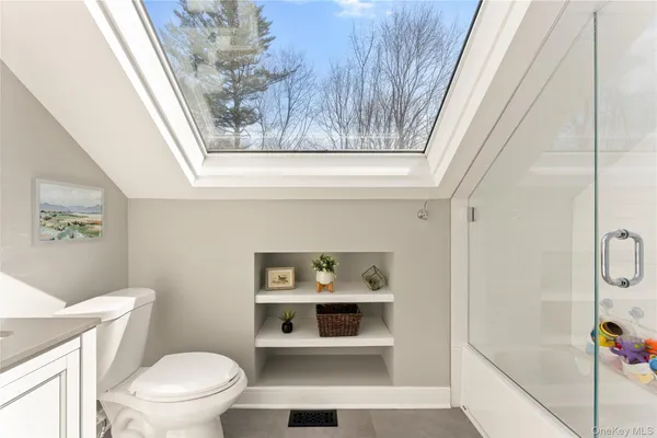 a bathroom with a toilet and a shower