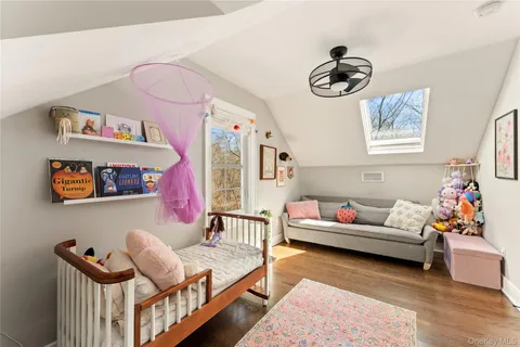 a living room with furniture and wall paintings