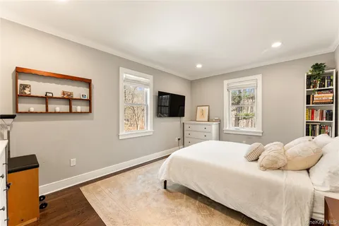 a bedroom with a large bed and a flat screen tv