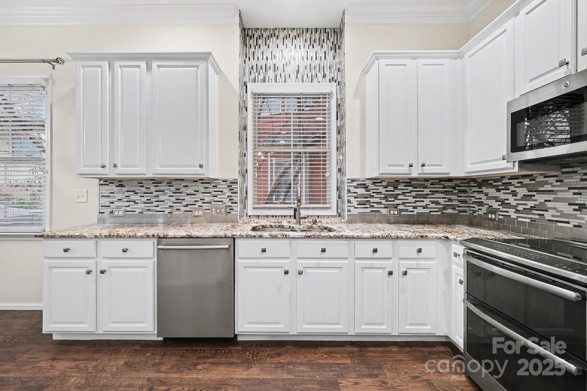 138 Blandina Court Fort Mill, SC 29708 - Photo 11 of 41 a kitchen with granite countertop a sink stove and cabinets
