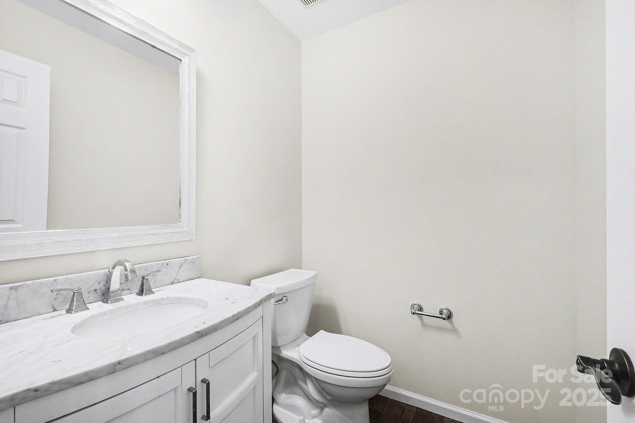 138 Blandina Court Fort Mill, SC 29708 - Photo 16 of 41 a bathroom with a granite countertop sink vanity mirror and toilet