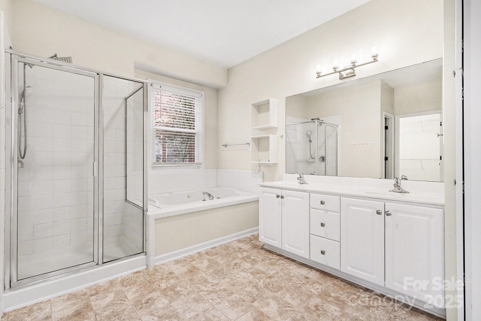 138 Blandina Court Fort Mill, SC 29708 - Photo 23 of 41 a bathroom with a granite countertop sink a mirror a bathtub and shower