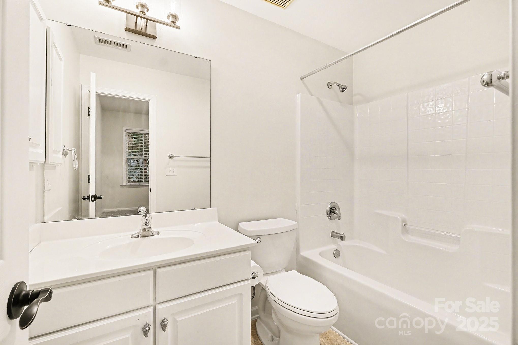 138 Blandina Court Fort Mill, SC 29708 - Photo 27 of 41 a bathroom with a sink a toilet a mirror a vanity and bathtub