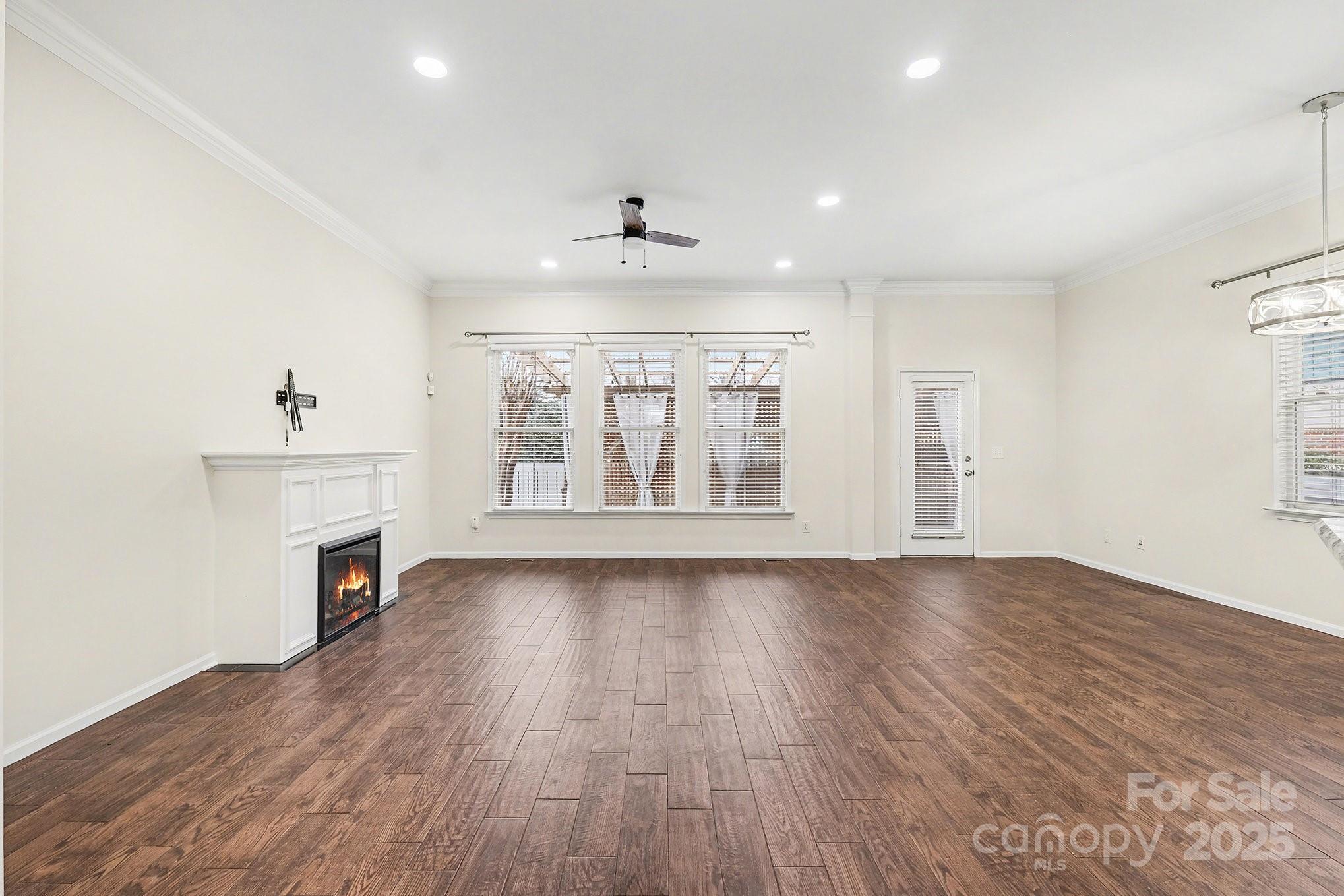 138 Blandina Court Fort Mill, SC 29708 - Photo 7 of 41 an empty room with wooden floor fireplace and windows